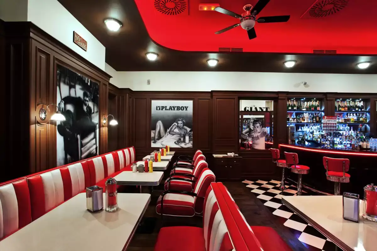 Boxy s červenobílými sedačkami a bar v pozadí